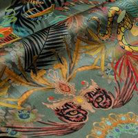 Close-up of the jaguar on Amazon Trip jade green patterned velvet upholstery fabric