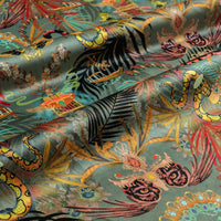 Rippled lengths of Amazon Trip jade green jungle print velvet fabric for upholstery and cushions