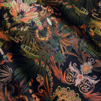 Amazon Trip black and gold velvet fabric draped in soft folds, showing how the jungle print falls for curtains and blinds