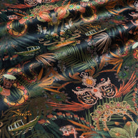 Amazon Trip velvet fabric in black and gold photographed at an angle to show the subtle sheen