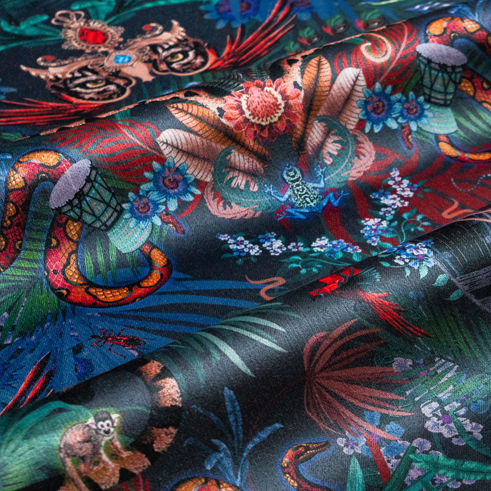 Rippled lengths of Amazon Trip midnight blue jungle print velvet fabric for upholstery and cushions