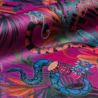 Detail of the macaws and rainbow boa on violet jungle print velvet furnishing fabric
