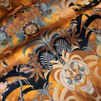 Rippled lengths of Balloon Safari mustard yellow African animal print velvet fabric for upholstery and cushions