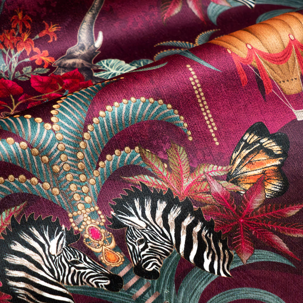 Rippled lengths of Balloon Safari pink and claret animal print velvet fabric for upholstery and cushions