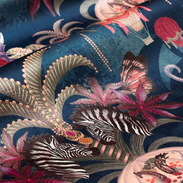Detail of the zebras on sapphire blue African animal print velvet furnishing fabric