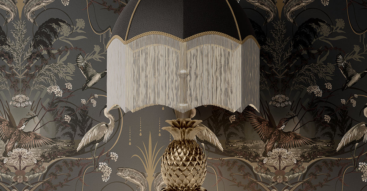 Dark interiors with dramatic charcoal designer wallpaper behind lamp