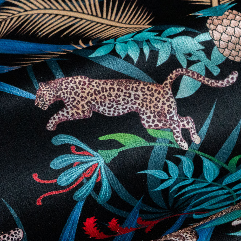 Rippled lengths of Leopard Luxe black and gold ornamental pattern velvet fabric for upholstery and cushions