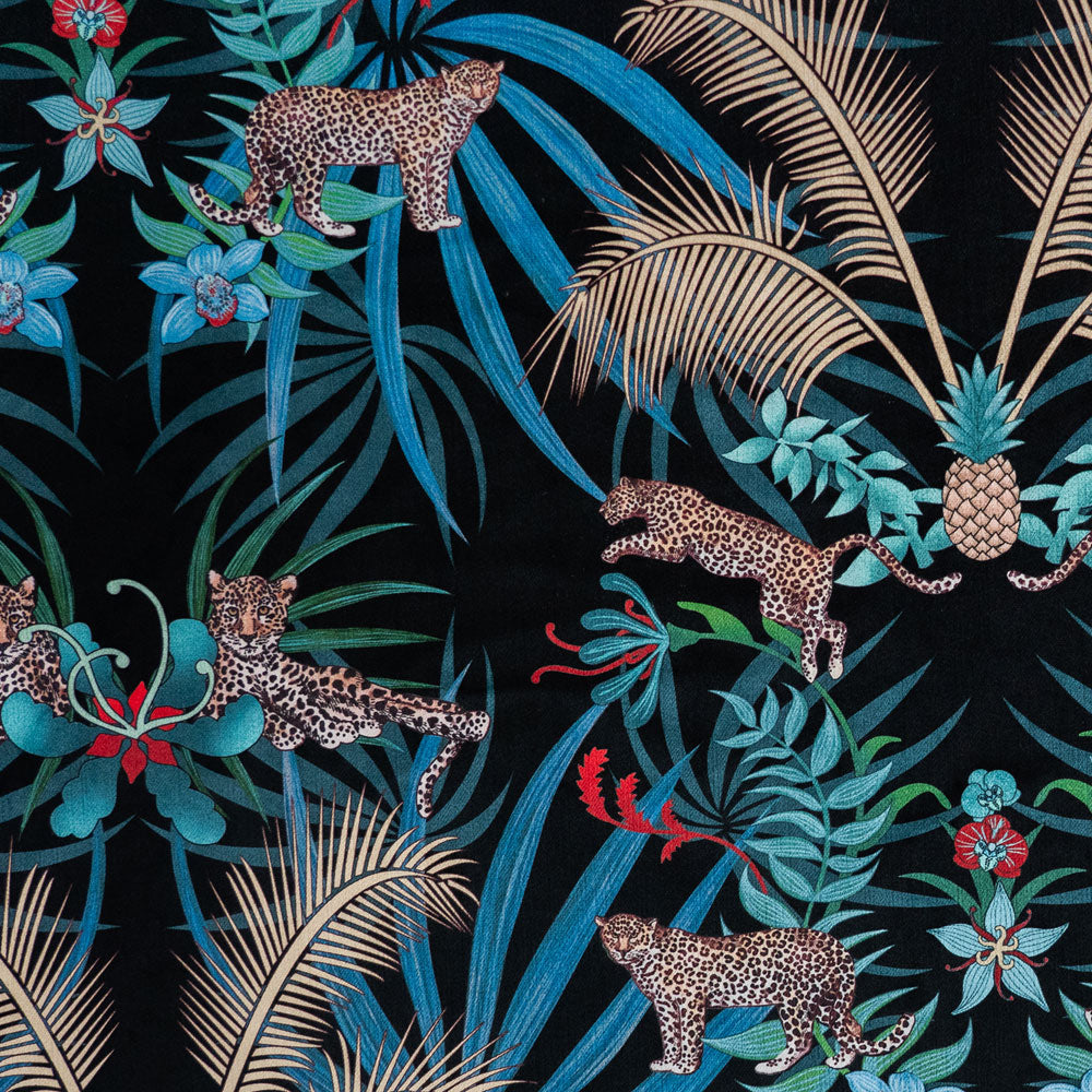 Detail of the leopards and gold palms pattern artwork on black velvet furnishing fabric