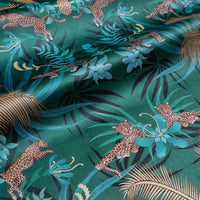 Rippled lengths of Leopard Luxe green and gold ornamental pattern velvet fabric for upholstery and cushions