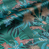 Leopard Luxe green and gold velvet fabric draped in soft folds, showing how the ornamental pattern falls for curtains and blinds