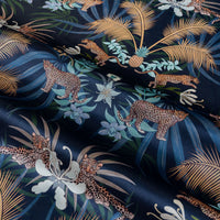 Rippled lengths of Leopard Luxe navy blue and gold ornamental pattern velvet fabric for upholstery and cushions