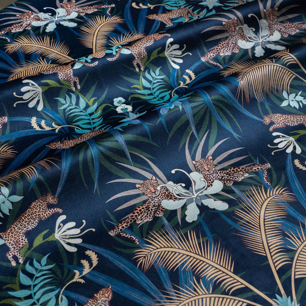 Leopard Luxe navy blue and gold velvet fabric draped in soft folds, showing how the ornamental pattern falls for curtains and blinds