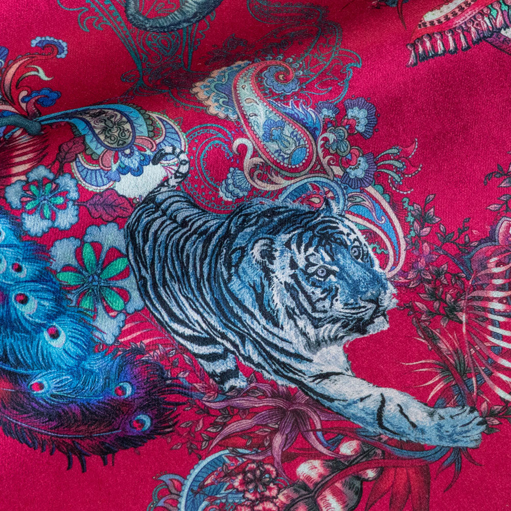 Detail of the Bengal tiger on bright pink Indian wildlife print velvet furnishing fabric