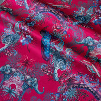 Magic Of India bright pink velvet fabric draped in soft folds, showing how the Indian wildlife print falls for curtains and blinds