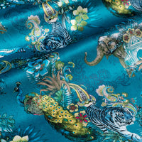 Rippled lengths of Magic Of India teal blue Indian wildlife print velvet fabric for upholstery and cushions