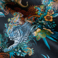 Detail of the Bengal tiger on black Indian wildlife print velvet furnishing fabric