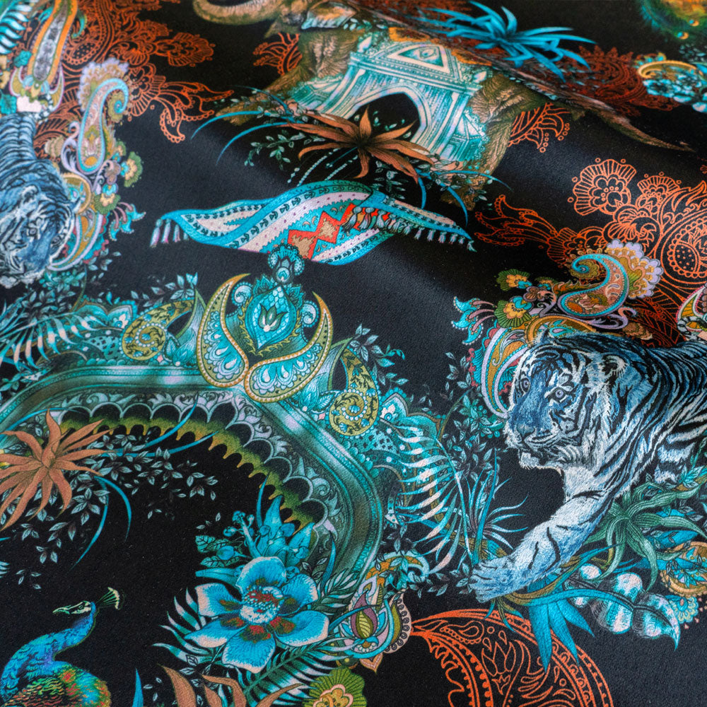 Magic Of India black velvet fabric draped in soft folds, showing how the Indian wildlife print falls for curtains and blinds