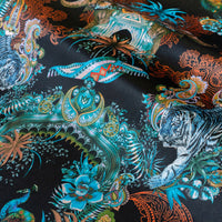 Magic Of India black velvet fabric draped in soft folds, showing how the Indian wildlife print falls for curtains and blinds