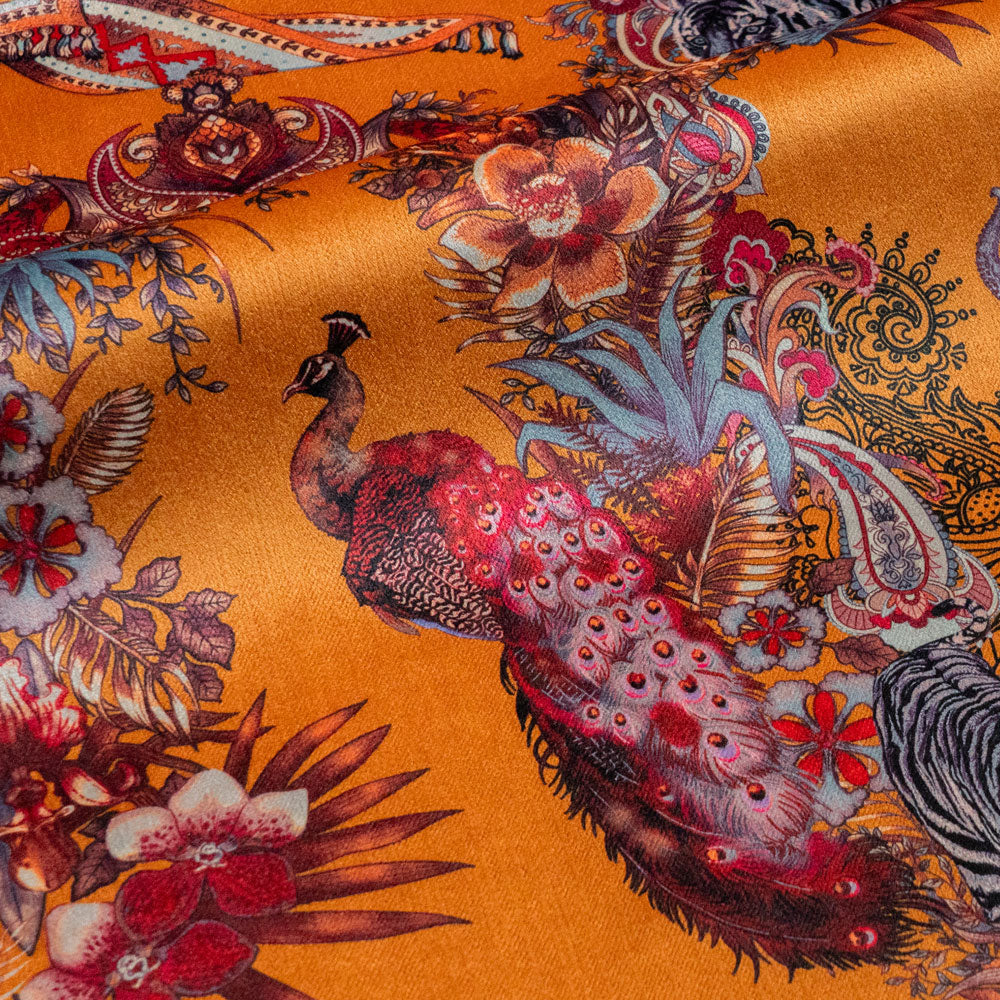 Close-up of the peacock on Magic Of India orange yellow patterned velvet upholstery fabric