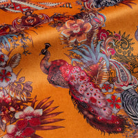 Close-up of the peacock on Magic Of India orange yellow patterned velvet upholstery fabric