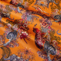 Magic Of India orange yellow velvet fabric draped in soft folds, showing how the Indian wildlife print falls for curtains and blinds