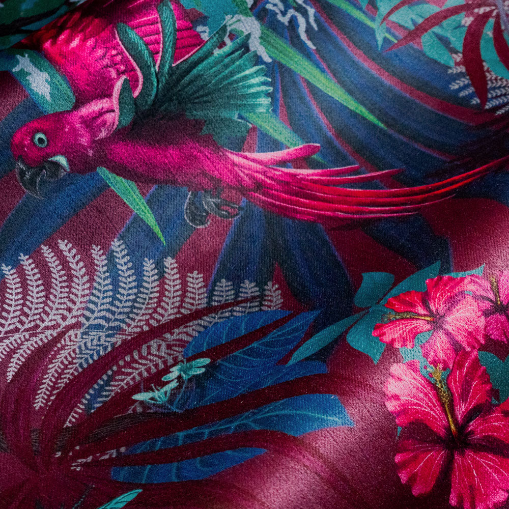 Close-up of a tropical bird and flowers on Rainforest Rush hot pink and claret patterned velvet upholstery fabric