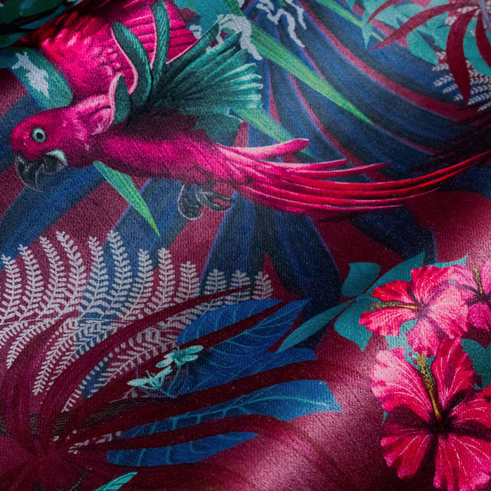 Close-up of a tropical bird and flowers on Rainforest Rush hot pink and claret patterned velvet upholstery fabric
