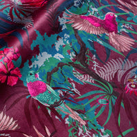 Rainforest Rush hot pink and claret velvet fabric draped in soft folds, showing how the tropical bird print falls for curtains and blinds