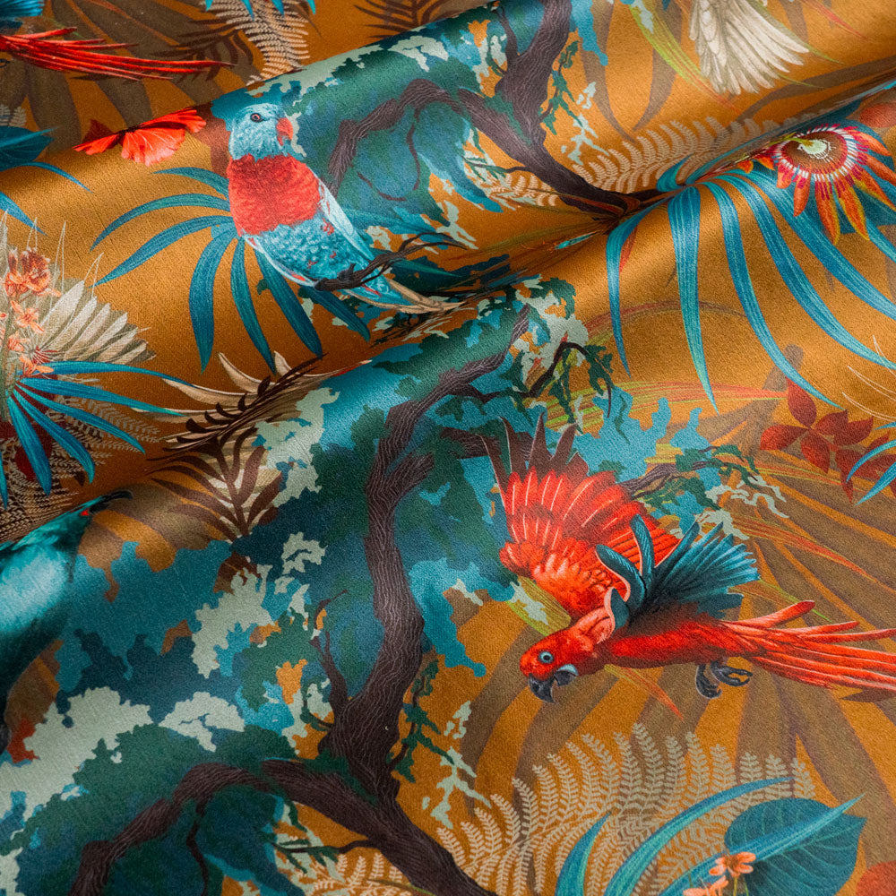 Rippled lengths of Rainforest Rush mustard yellow tropical bird print velvet fabric for upholstery and cushions