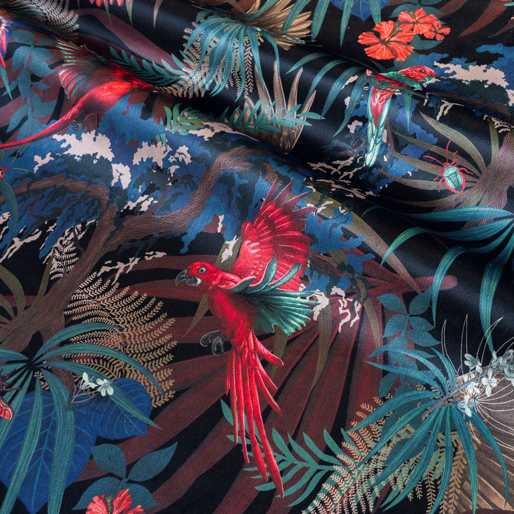 Detail of the birds and flowers on black red and gold tropical bird print velvet furnishing fabric