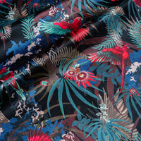 Rainforest Rush black red and gold velvet fabric draped in soft folds, showing how the tropical bird print falls for curtains and blinds