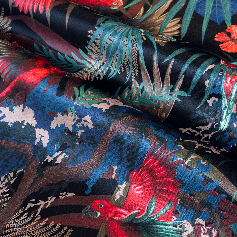 Rainforest Rush velvet fabric in black red and gold photographed at an angle to show the subtle sheen