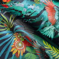Rippled lengths of Rainforest Rush colourful tropical bird print velvet fabric for upholstery and cushions