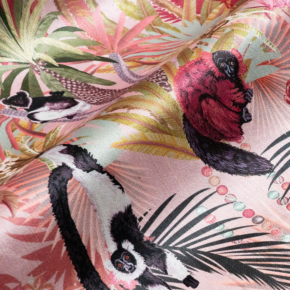 Detail of the lemurs on dawn pink lemur print velvet furnishing fabric