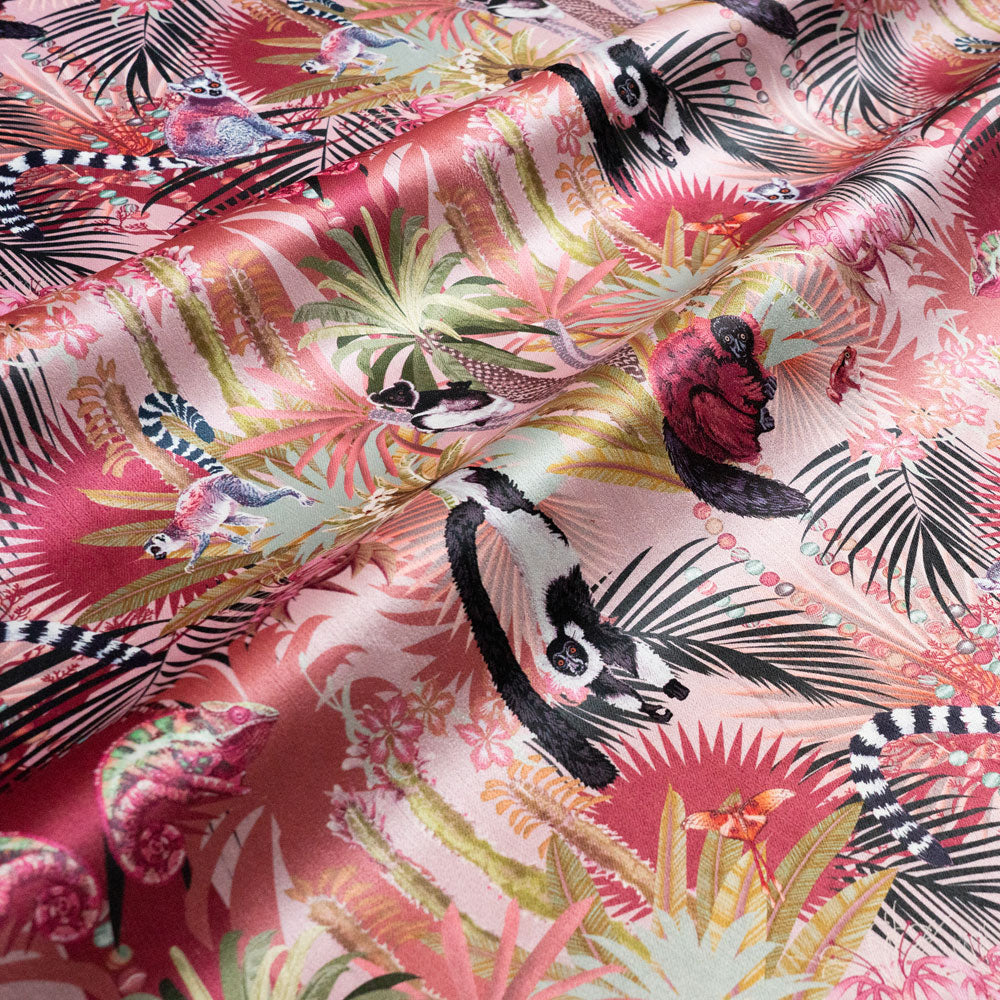Rippled lengths of Treetop Tango dawn pink lemur print velvet fabric for upholstery and cushions