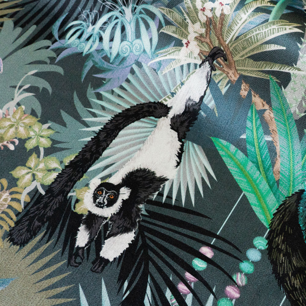 Close-up of the swinging lemur on Treetop Tango dusky blue patterned velvet upholstery fabric