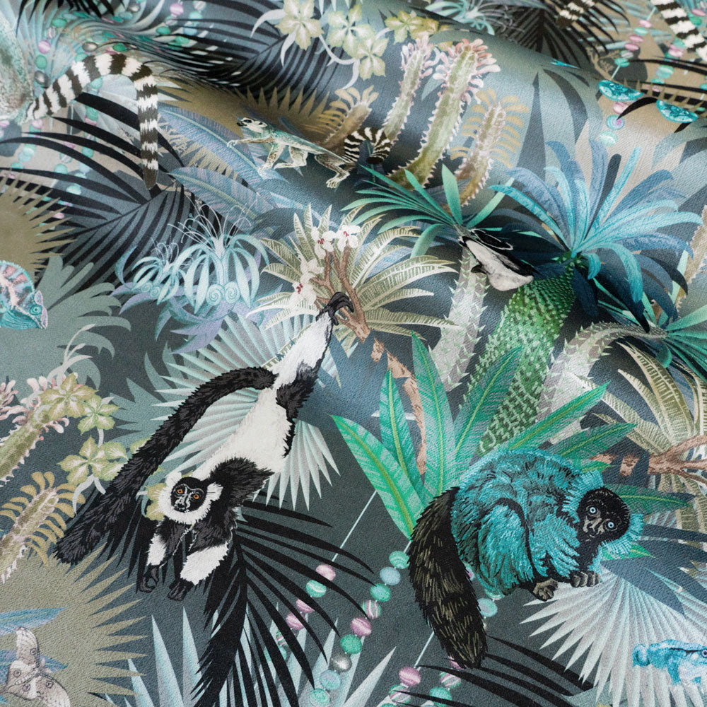 Treetop Tango dusky blue velvet fabric draped in soft folds, showing how the lemur print falls for curtains and blinds