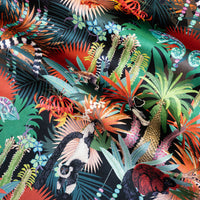 Rippled lengths of Treetop Tango dark colourful lemur print velvet fabric for upholstery and cushions
