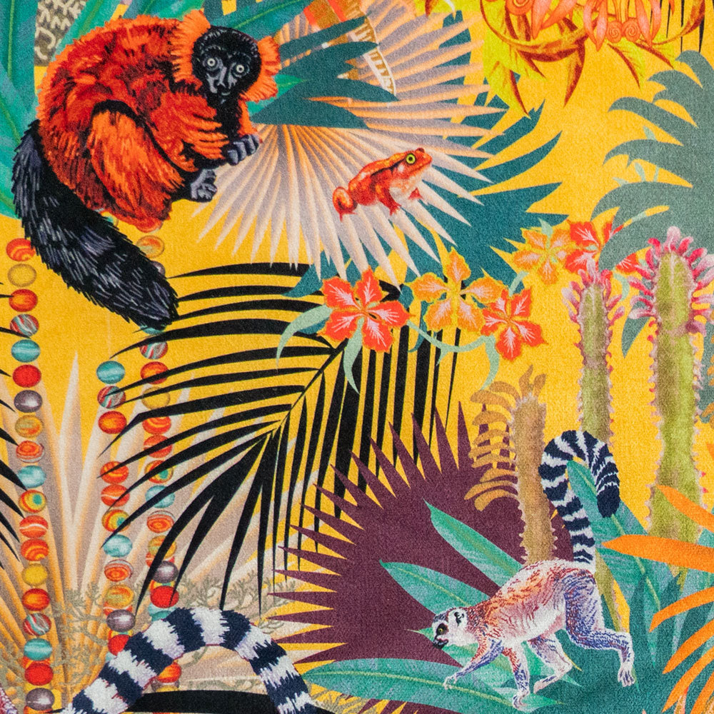 Close-up of lemurs, tomato frog and agate bead strands on Treetop Tango lemur print velvet fabric in sunshine yellow