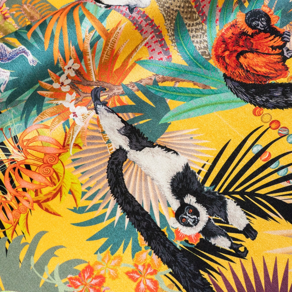 Close-up of swinging lemur on Treetop Tango lemur print velvet fabric in sunshine yellow