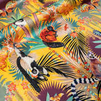 Rippled lengths of Treetop Tango sunshine yellow lemur print velvet fabric for upholstery and cushions