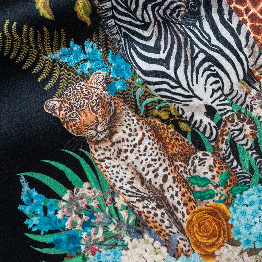 Close-up of the leopard on Wild Blooms black patterned velvet upholstery fabric
