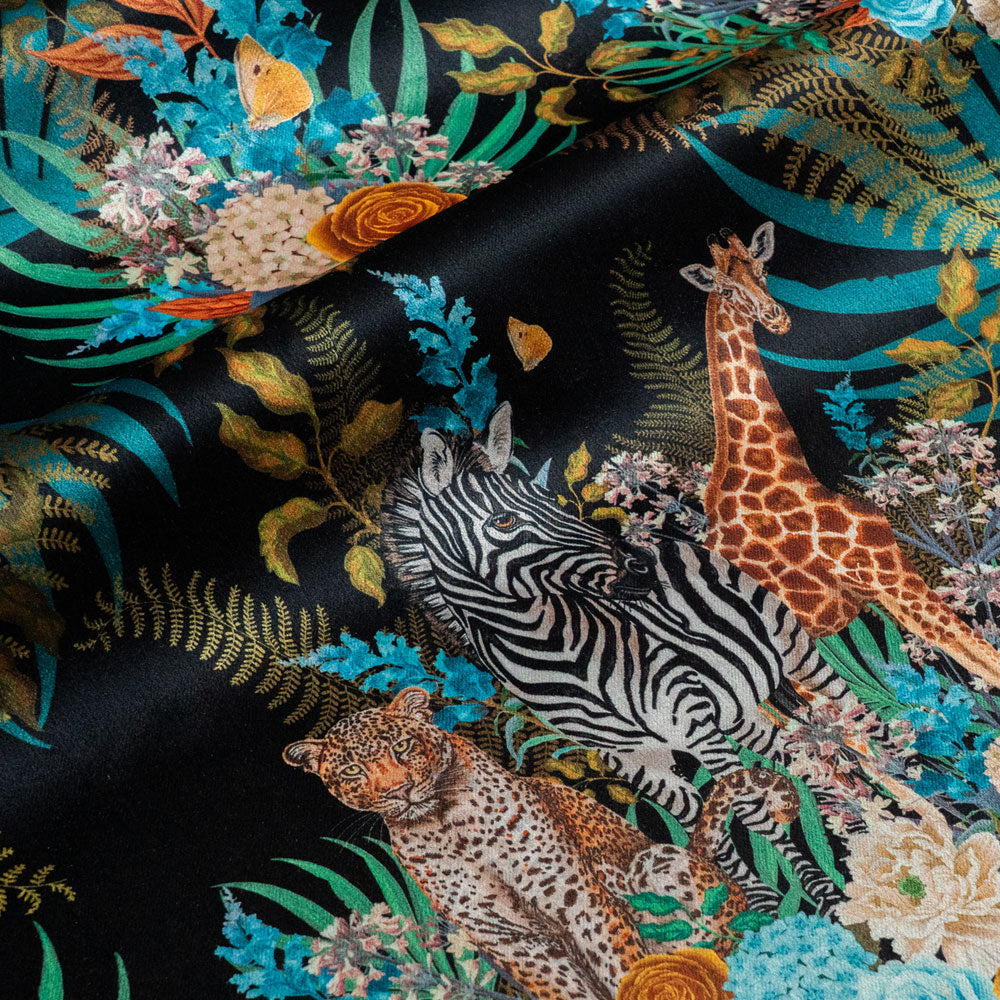 Rippled lengths of Wild Blooms black African animal and floral print velvet fabric for upholstery and cushions