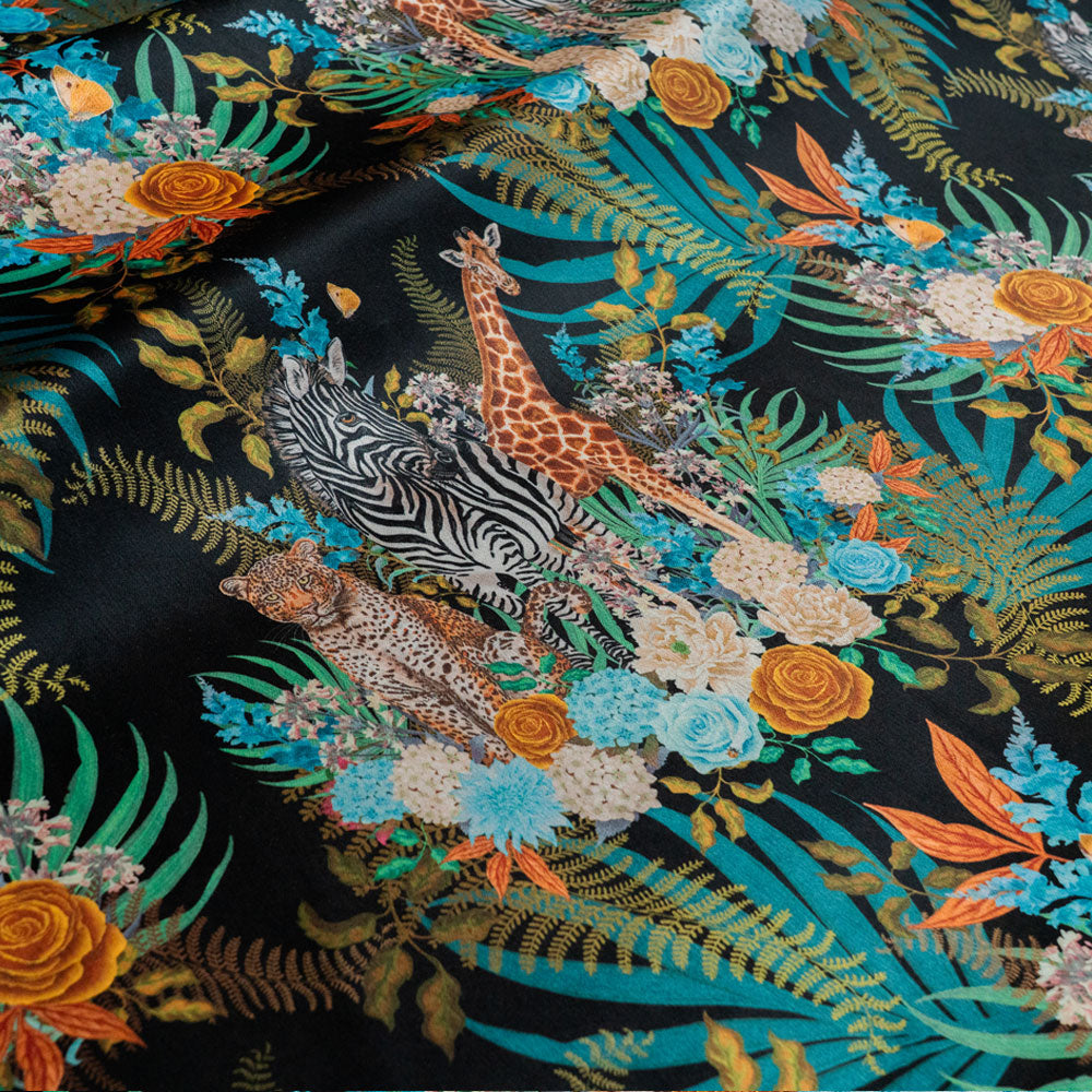 Wild Blooms black velvet fabric draped in soft folds, showing how the African animal and floral print falls for curtains and blinds