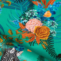 Close-up of blooming flowers on Wild Blooms African animal and floral print velvet fabric in green