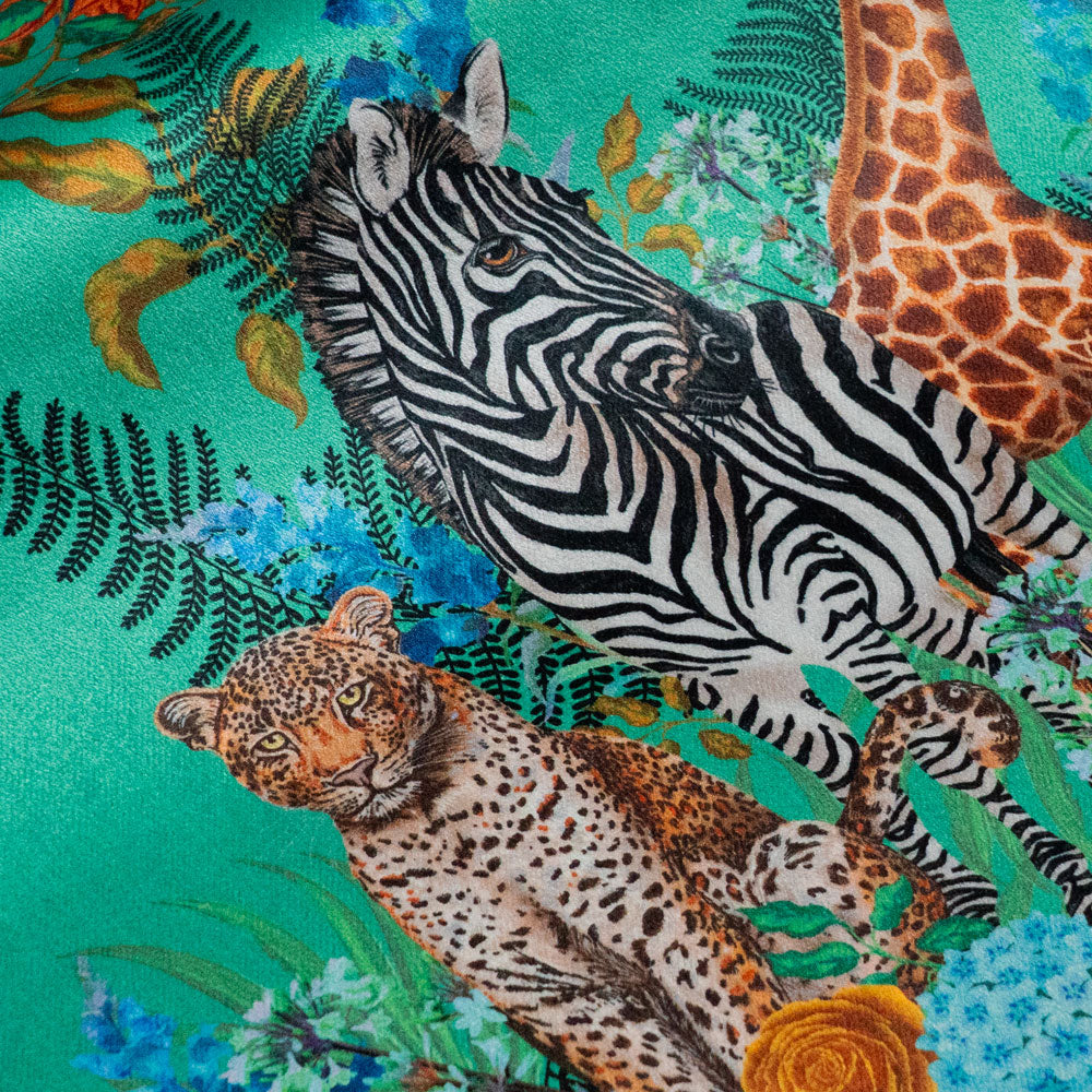 Close-up of the leopard and zebra on Wild Blooms green patterned velvet upholstery fabric