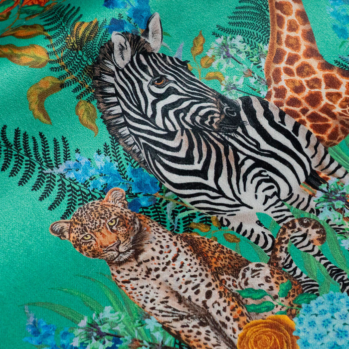 Close-up of the leopard and zebra on Wild Blooms green patterned velvet upholstery fabric