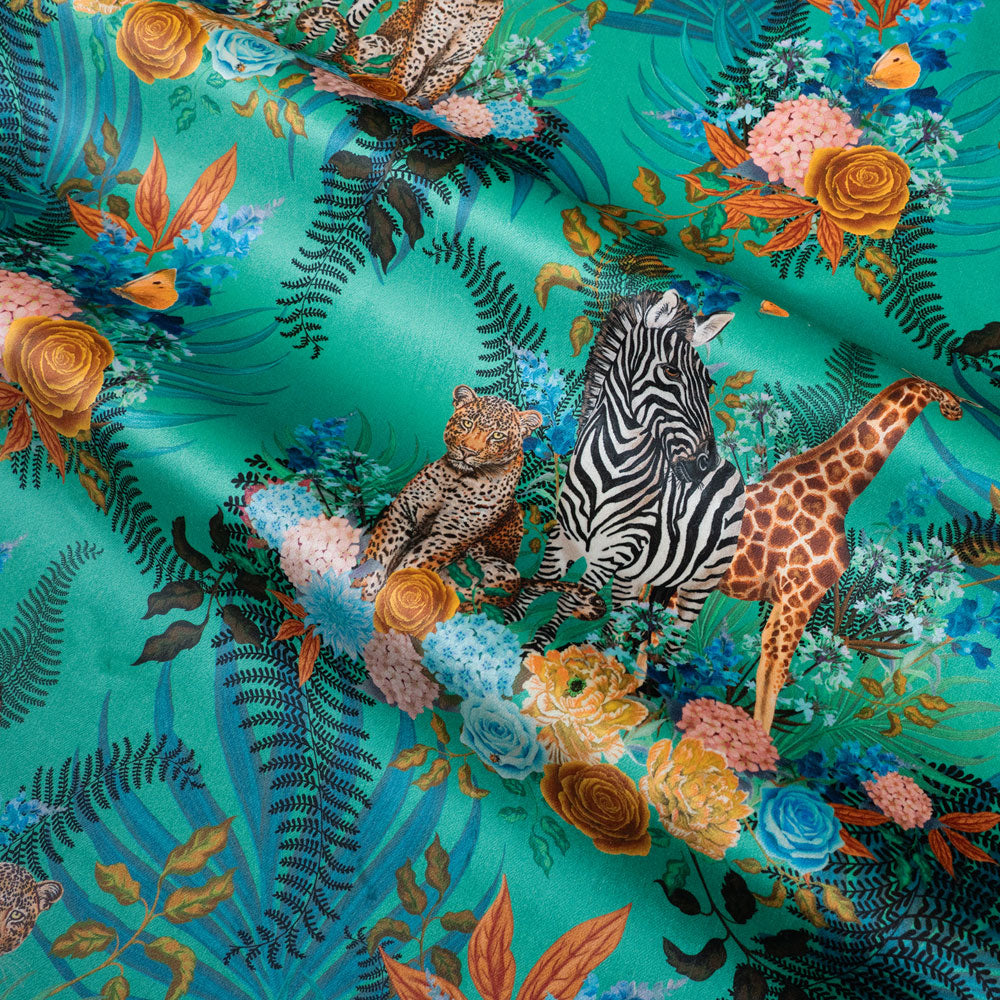 Rippled lengths of Wild Blooms green African animal and floral print velvet fabric for upholstery and cushions