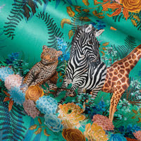 Wild Blooms green velvet fabric draped in soft folds, showing how the African animal and floral print falls for curtains and blinds