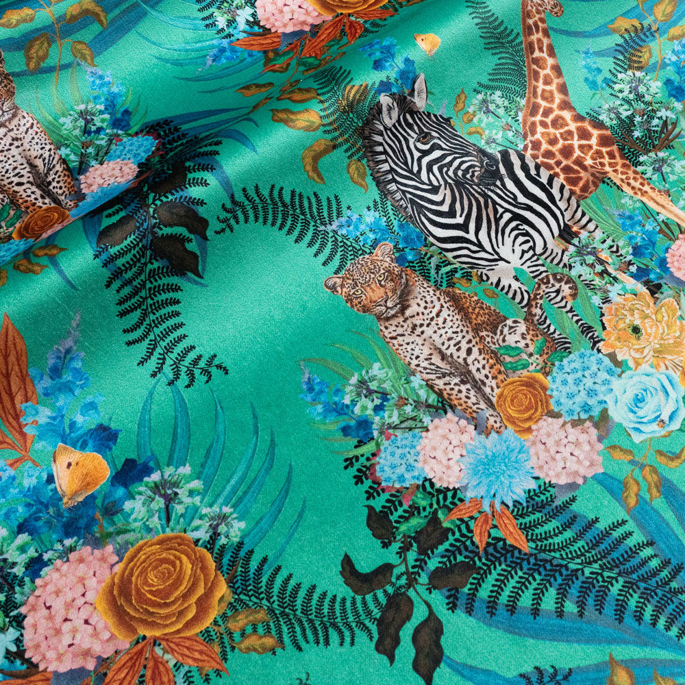 Wild Blooms velvet fabric in green photographed at an angle to show the subtle sheen